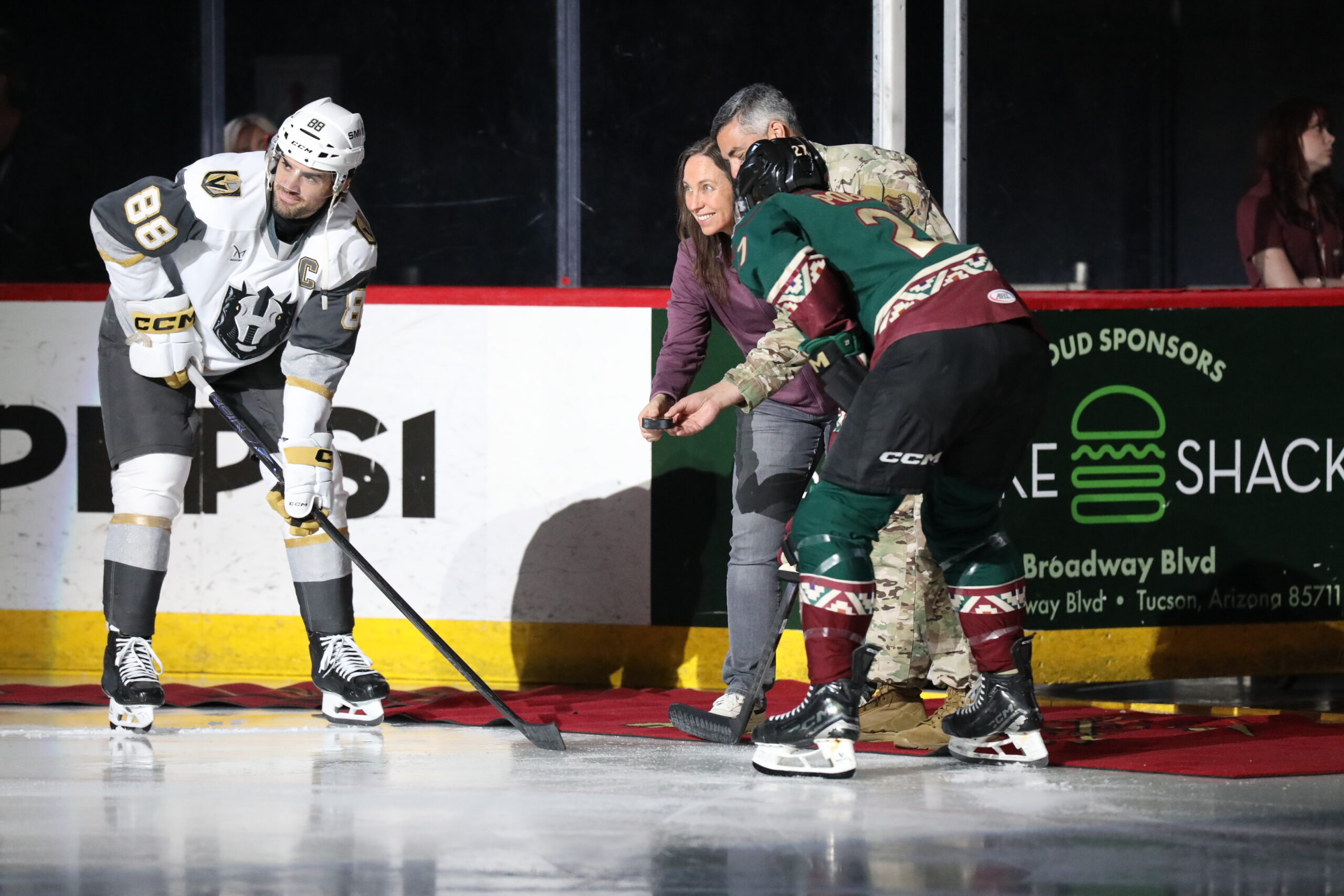 Fan dropping the ceremonial puck at a Roadrunners home game